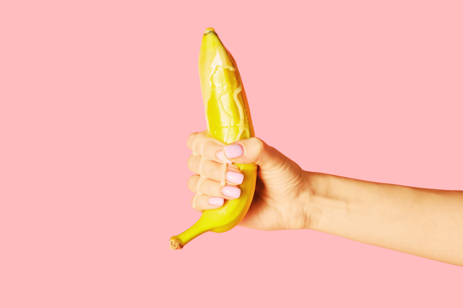 a hand holding a banana