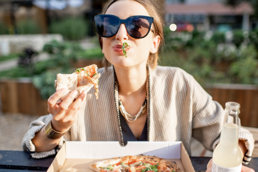 a woman eating pizza