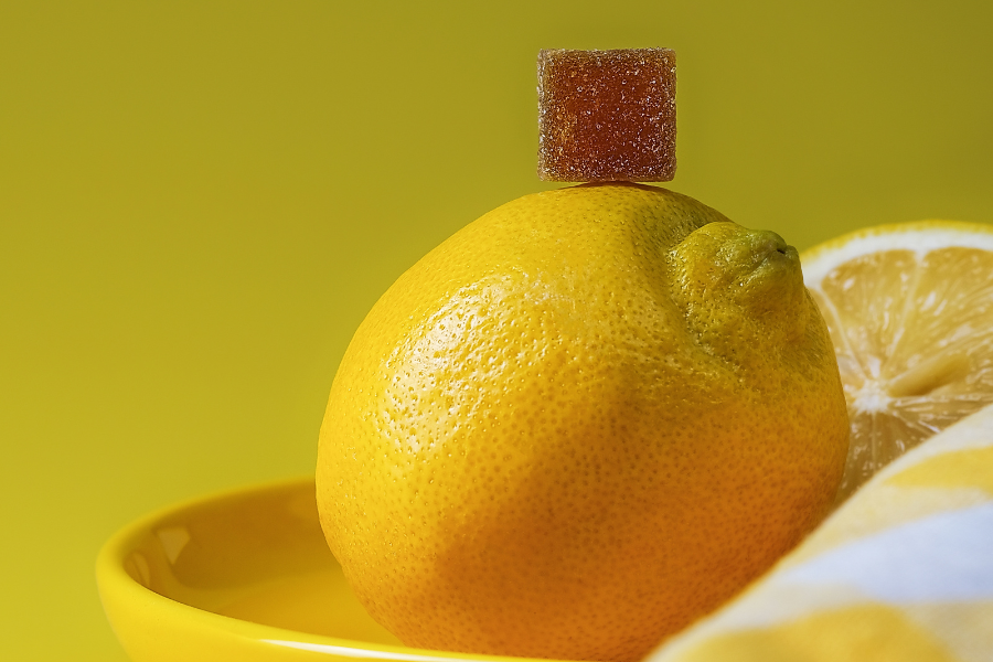 a gummy stacked on top of a lemon
