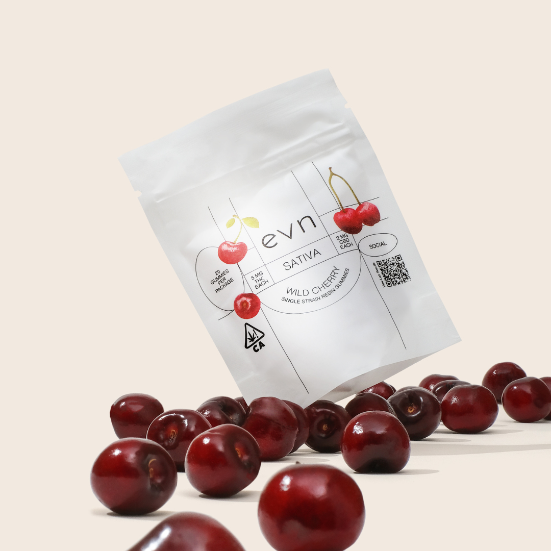 a bunch of cherries in front of a gummy pouch