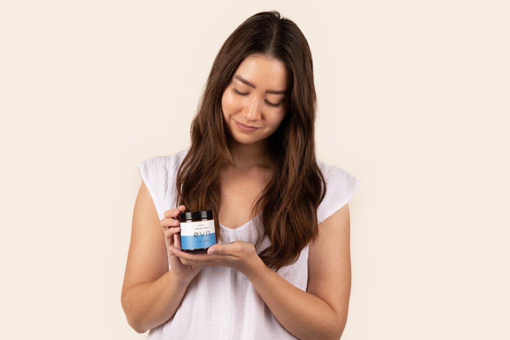 a girl holding a jar of cream
