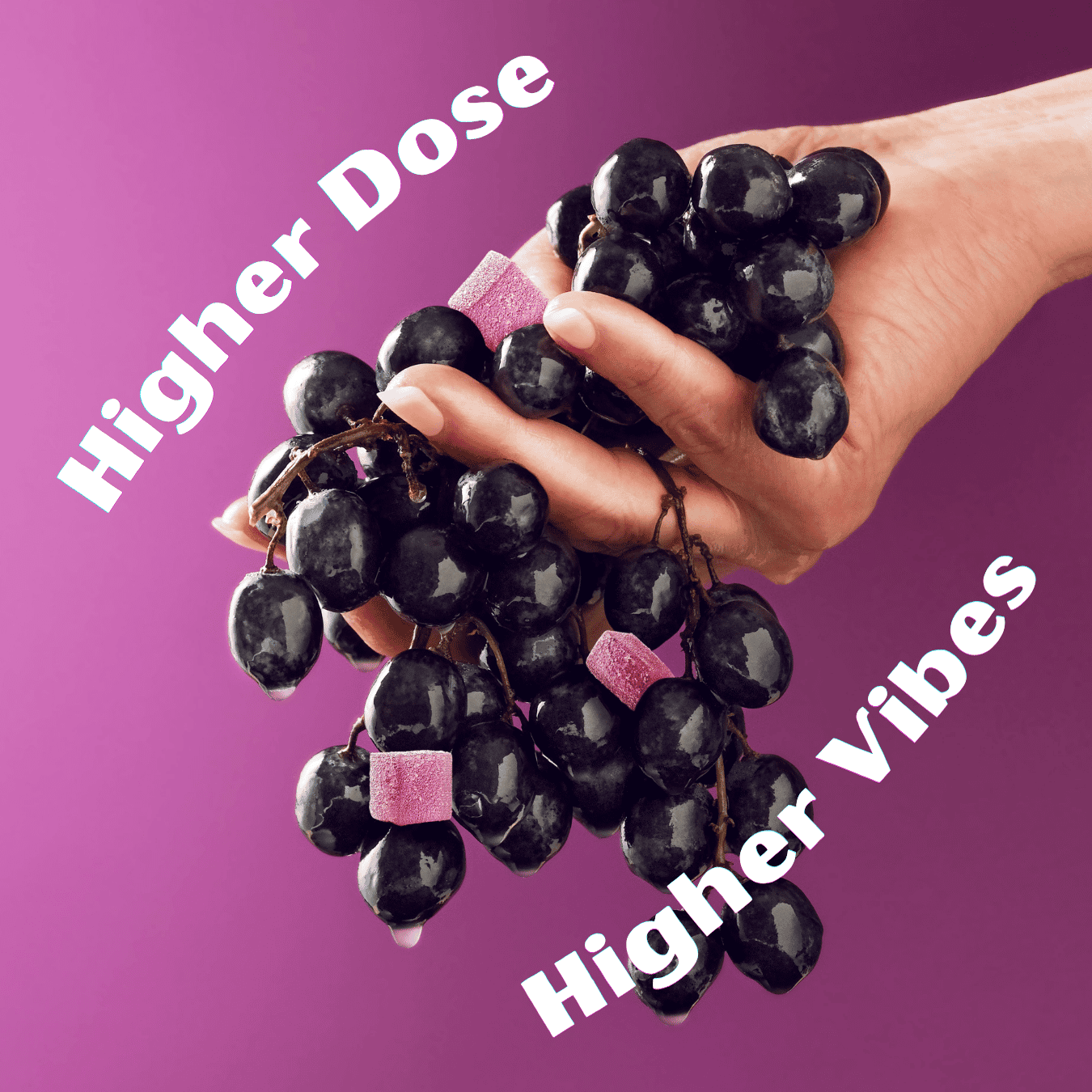 hand holding grapes and grape gummies