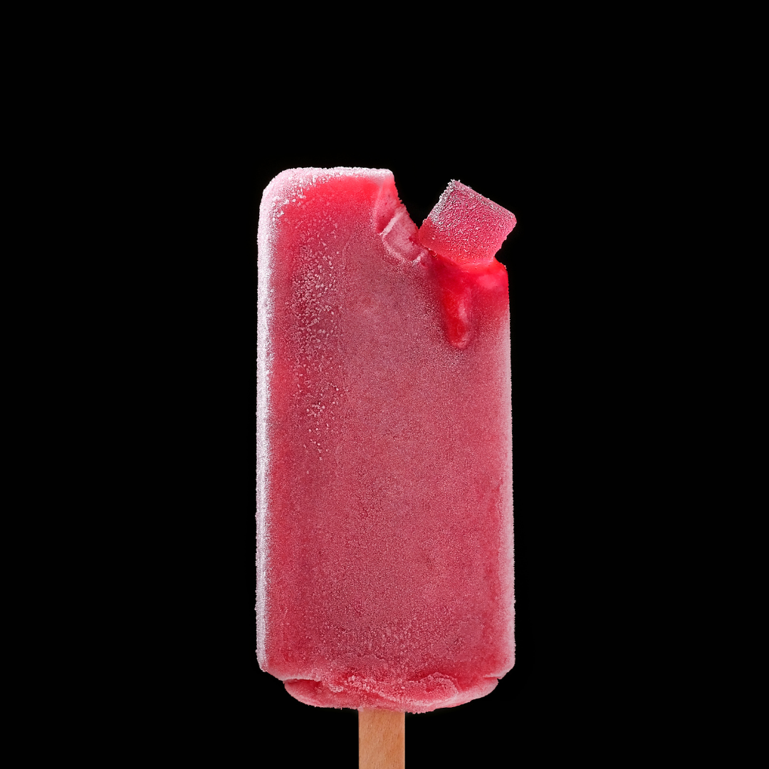 a raspberry gummy on a raspberry popsicle