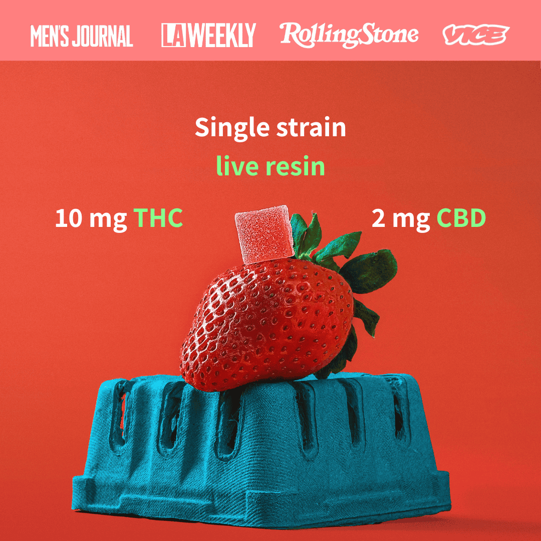 a gummy on top of a strawberry