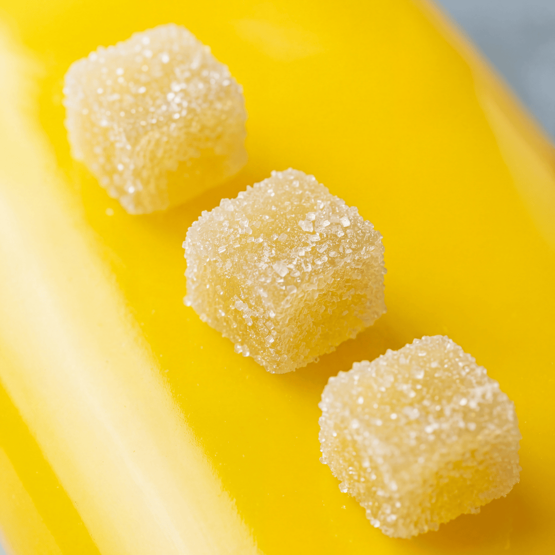 three pineapple gummies next to each other