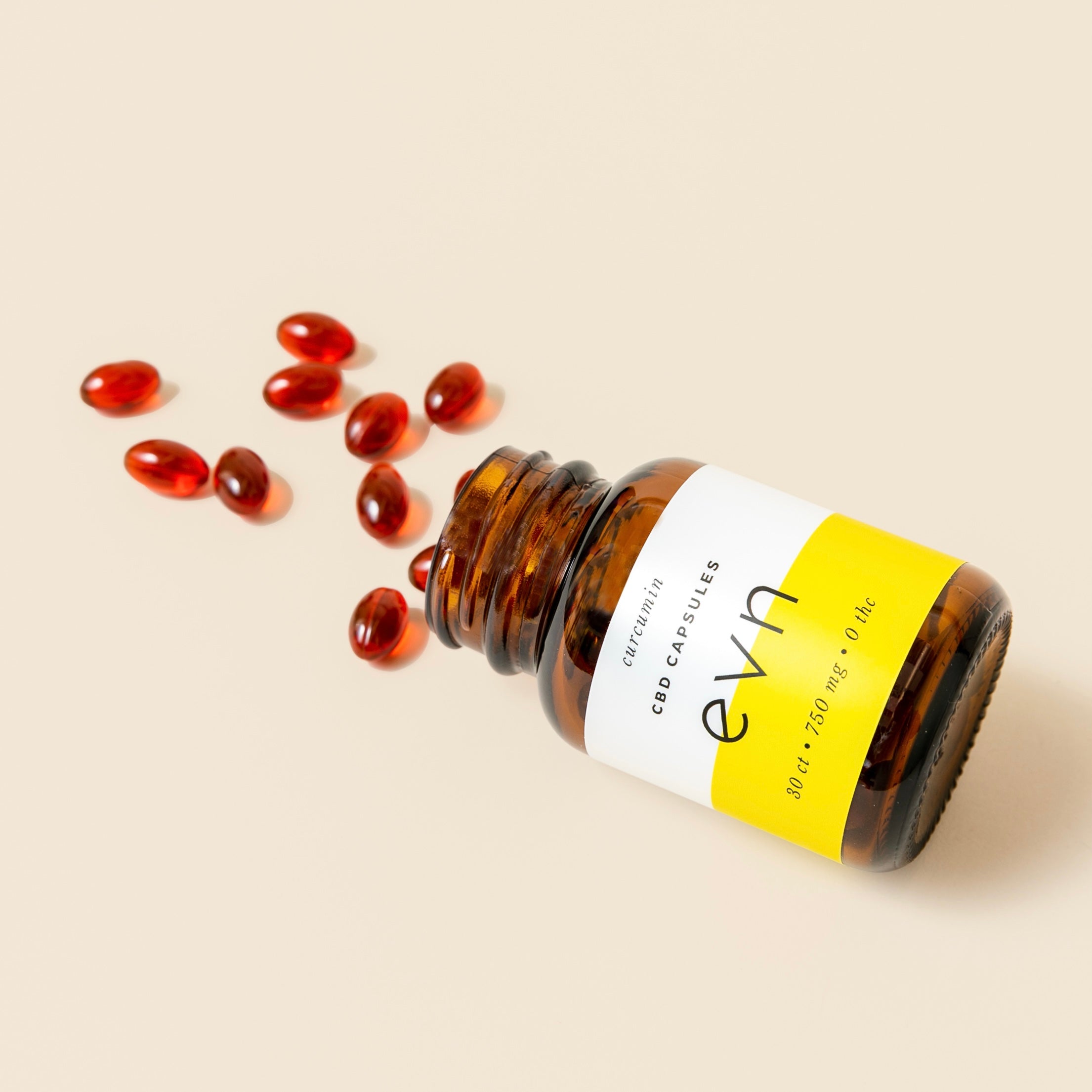 Evn-CBD-capsules-spilling-out-of-open-bottle