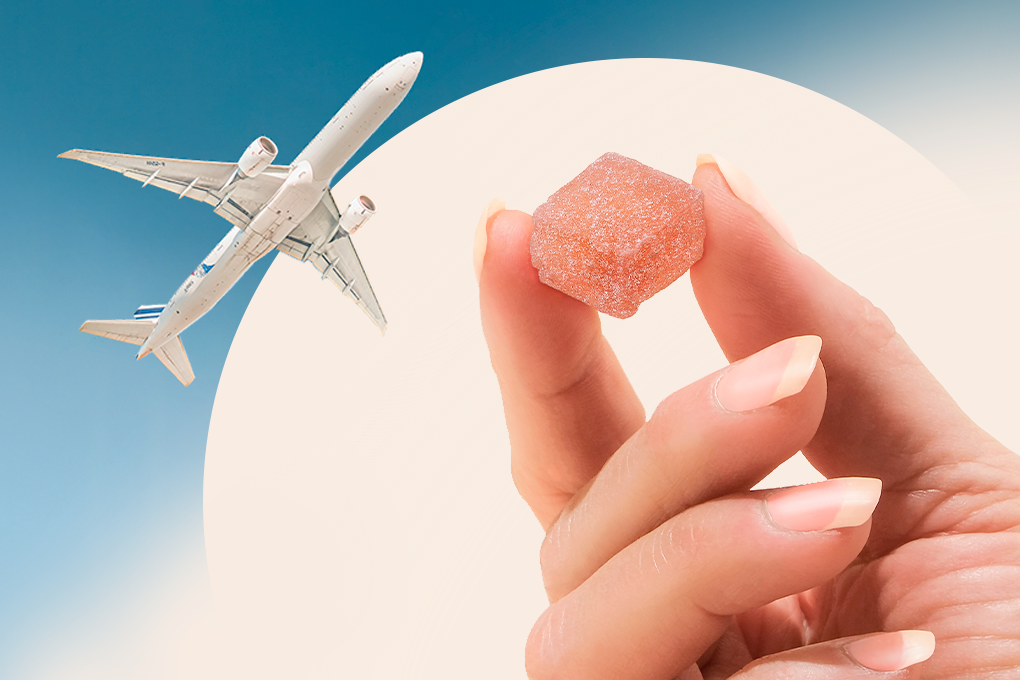 a person holding a piece of candy in a flying aeroplane backdrop
