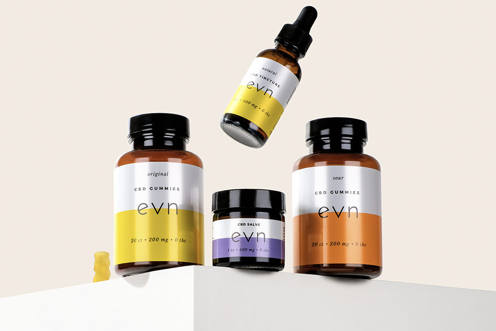 Assorted products from Evn CBD on a white table.