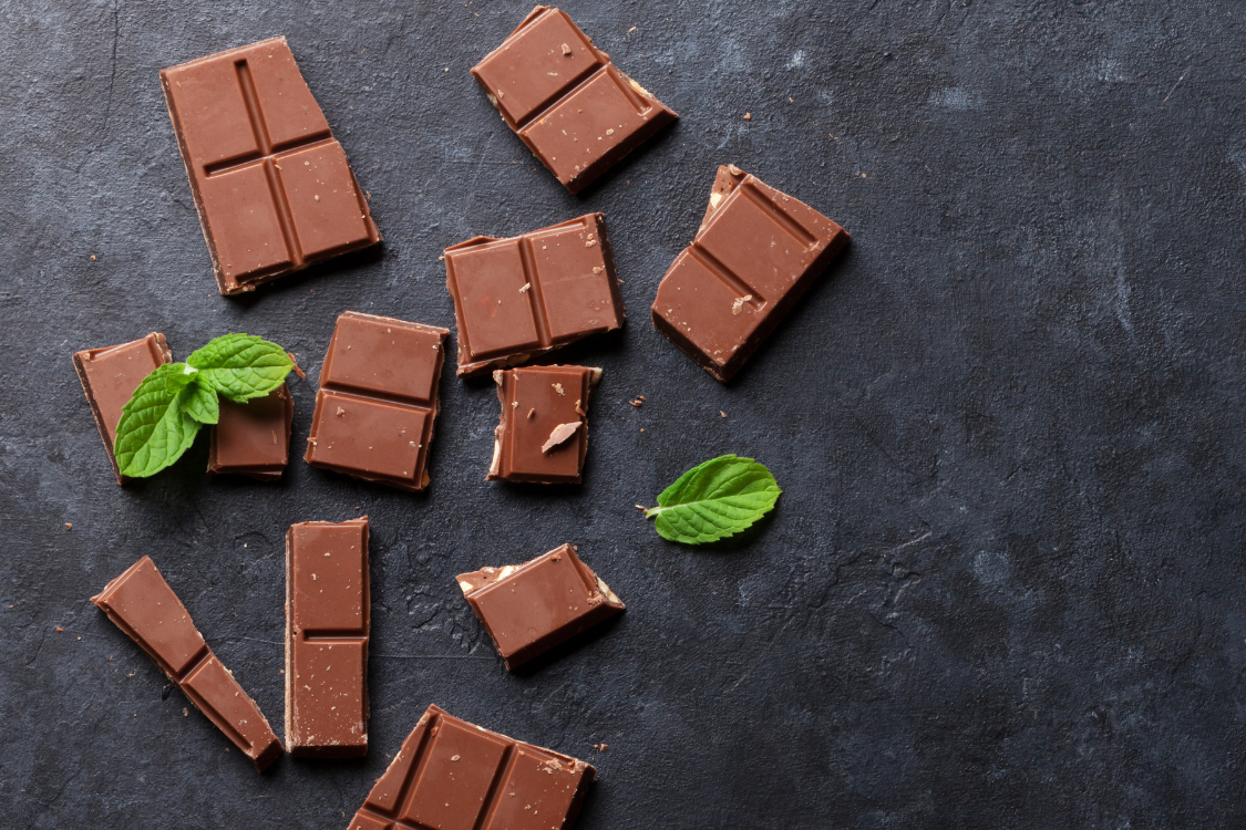cannabis chocolate bars crumbled on a table with mint leaves