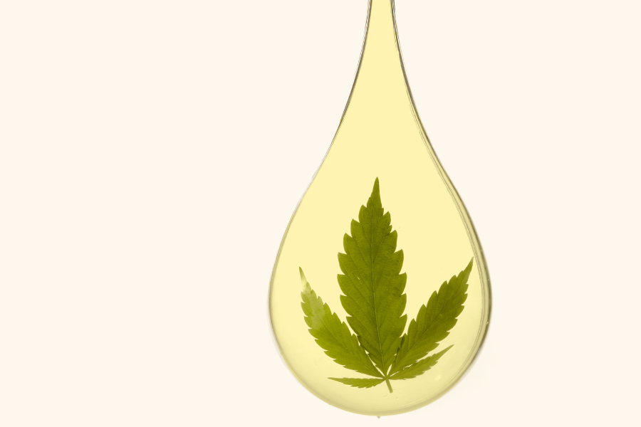 a drop of oil with a cannabis leaf in it