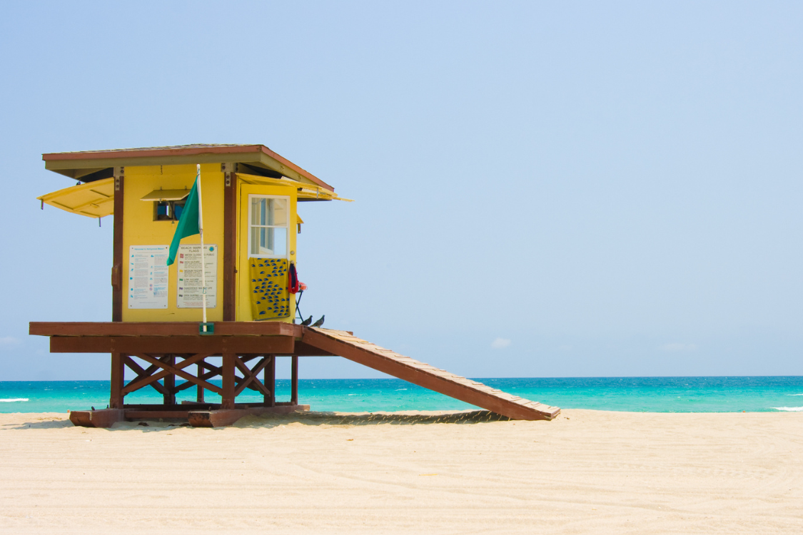 a yellow beach cabana on a florida beach
