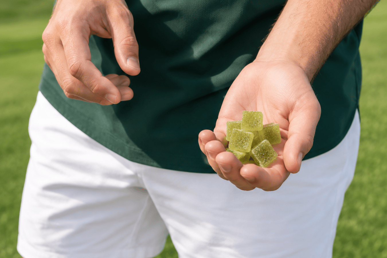 a guy holding a bunch of green cbg gummies