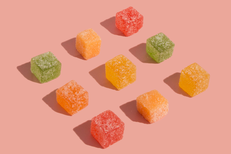 different colors of cube shaped gummies on a table