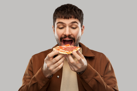 man eating a slice of pizza