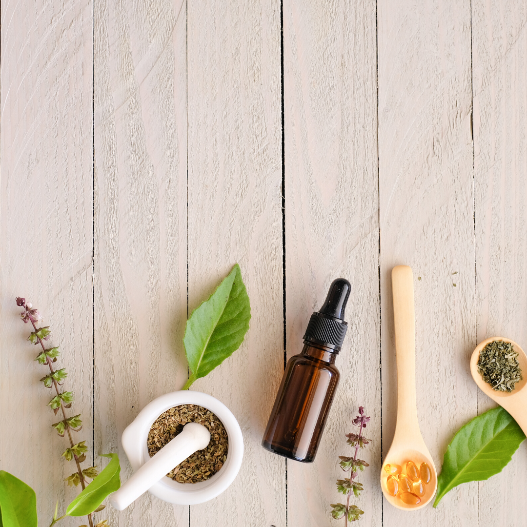 Plants and herbs with a tincture on a wooden floow