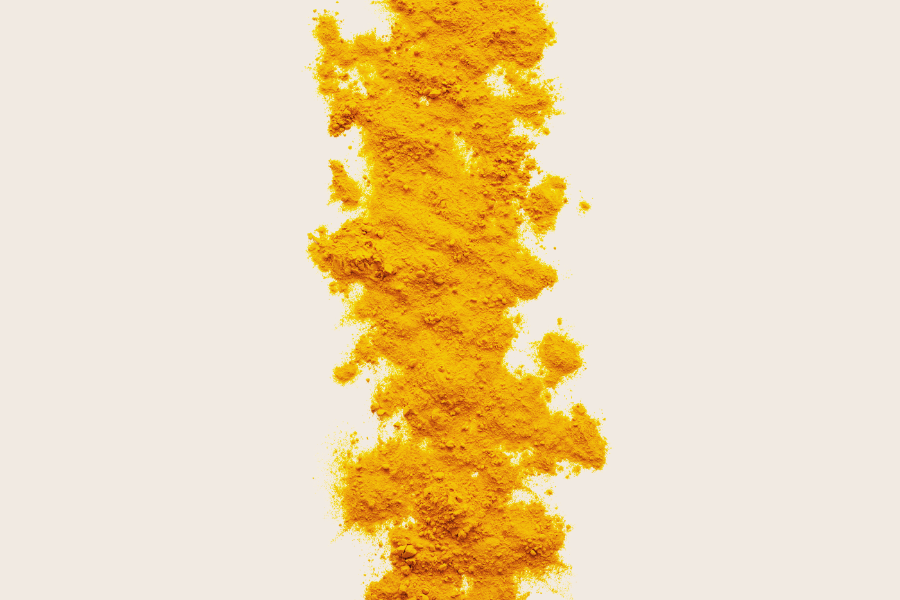 turmeric powder with a beige background