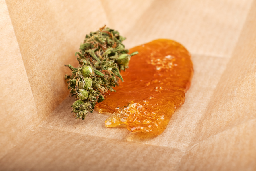 cannabis flower next to wax extract