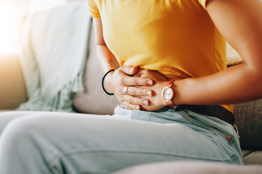 a woman holding her belly in pain