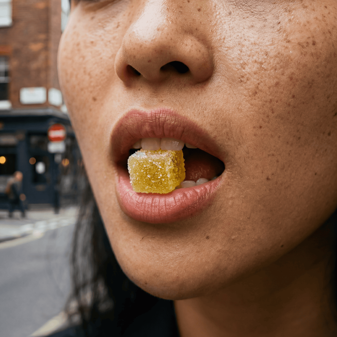 a girl biting into a gummy