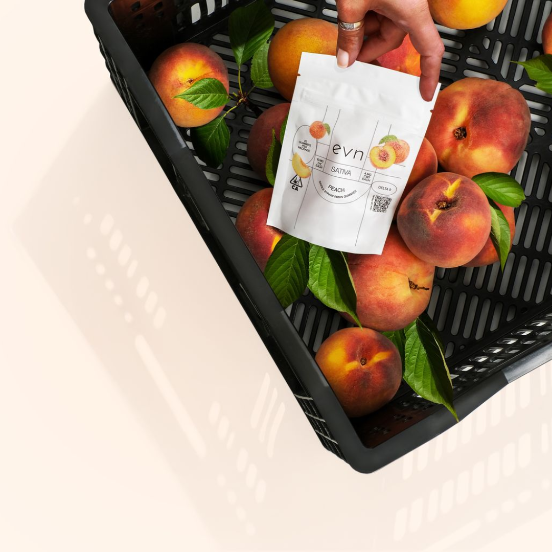 a basket of peaches with a pouch of peach gummies