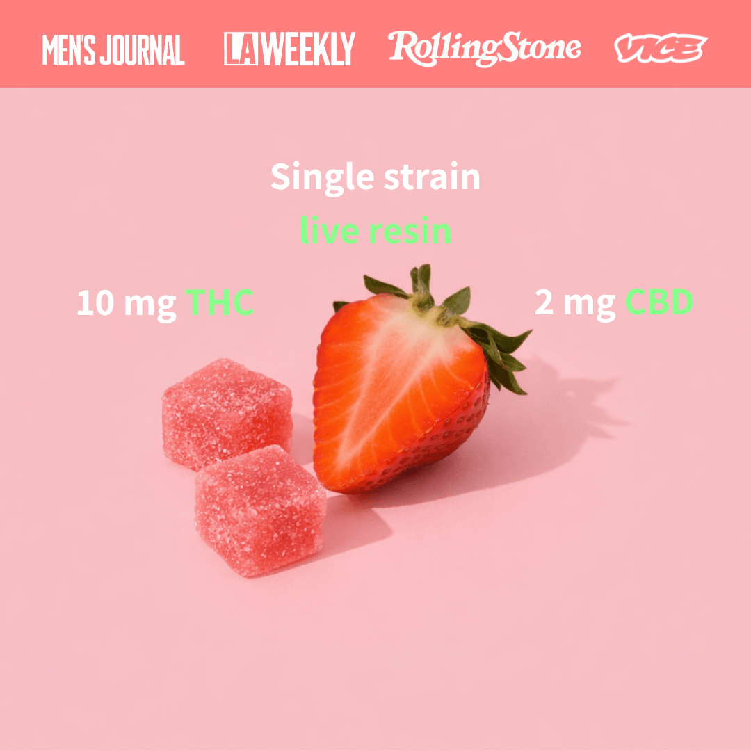 half cut strawberry next to gummies