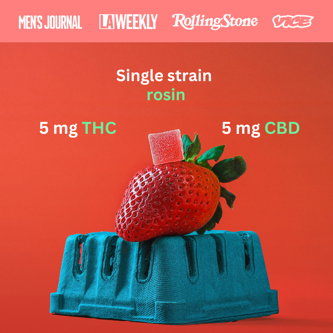 a gummy on top of a strawberry