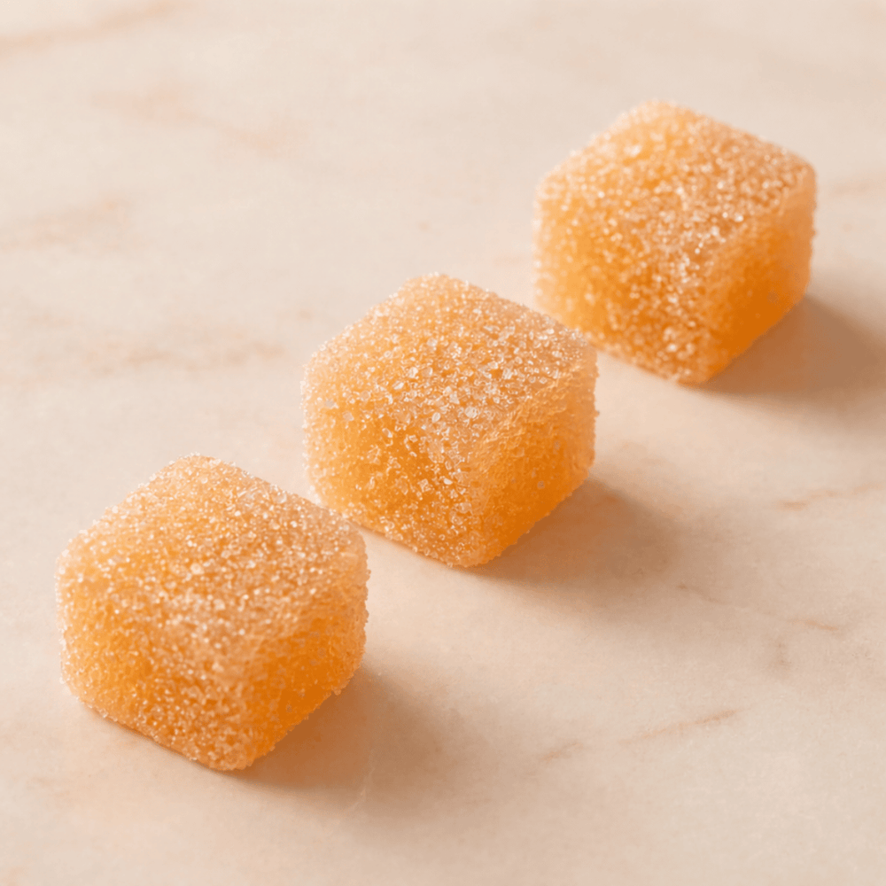 three orange gummies next to each other